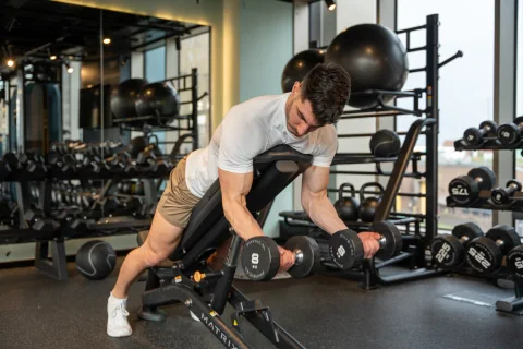 Atai training with dumbbells in the gym